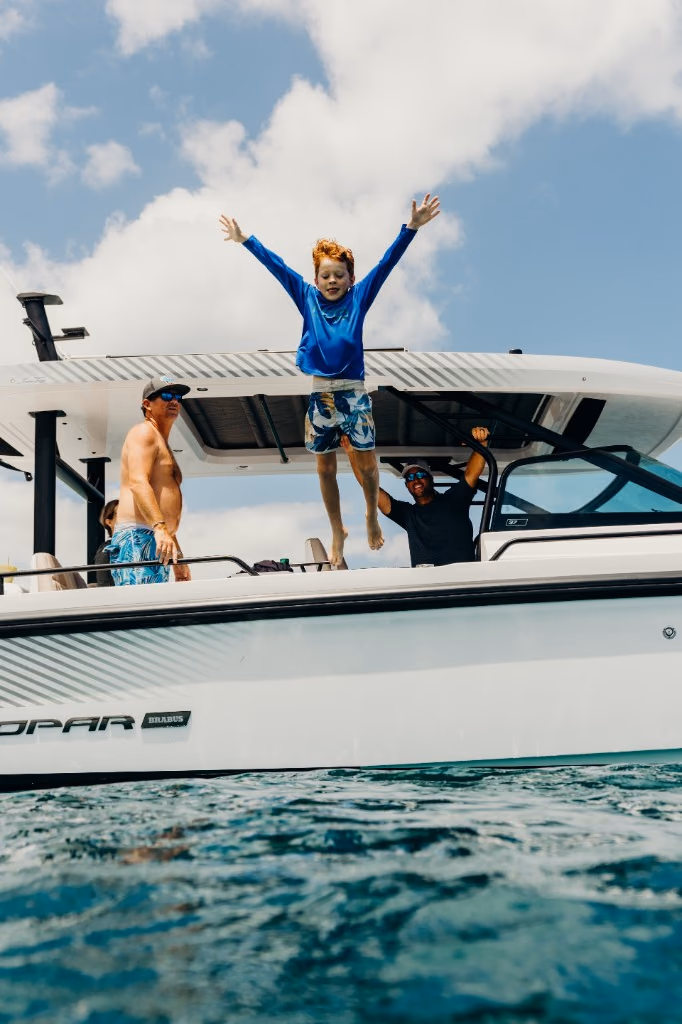 Boy jumping off Her Deal into the sea on a St. Thomas day charter