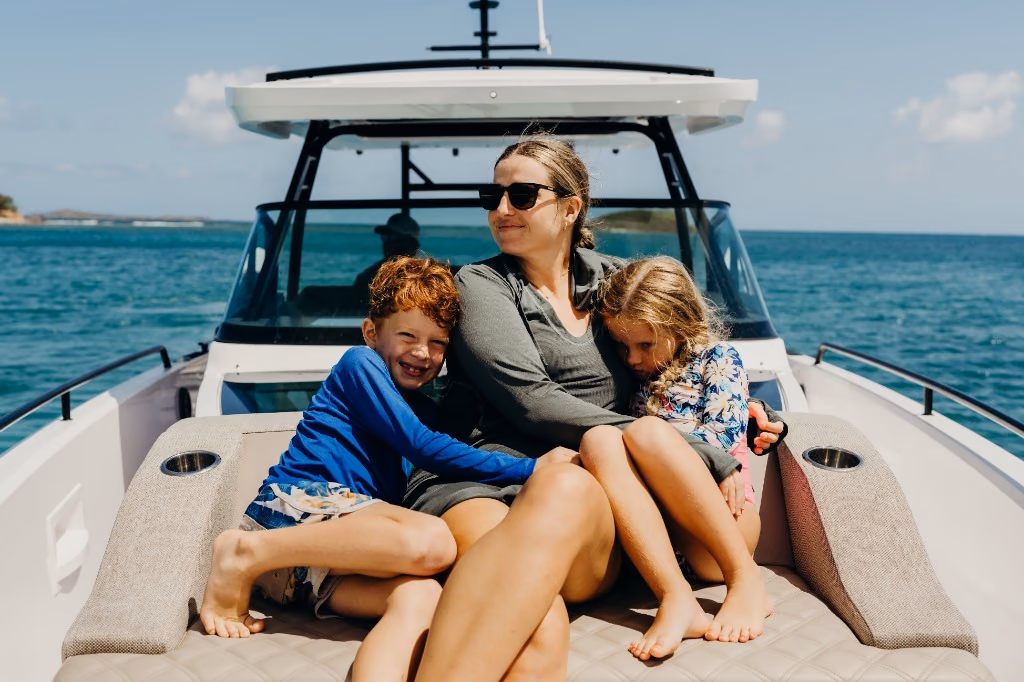 Mother with her two children in the bow seating of Her Deal in St. Thomas